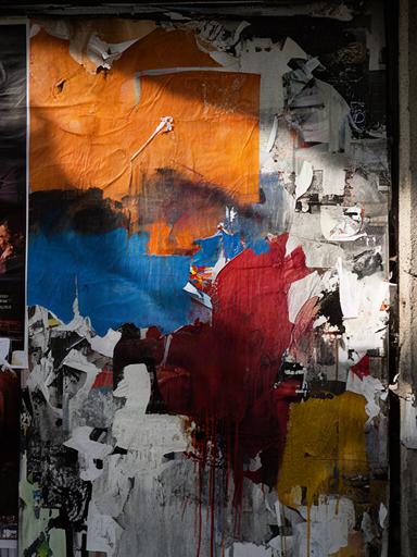 Überklebte Plakatwand im Zürcher Kreis 4 mit Konzertankündigungen und Farbschichten